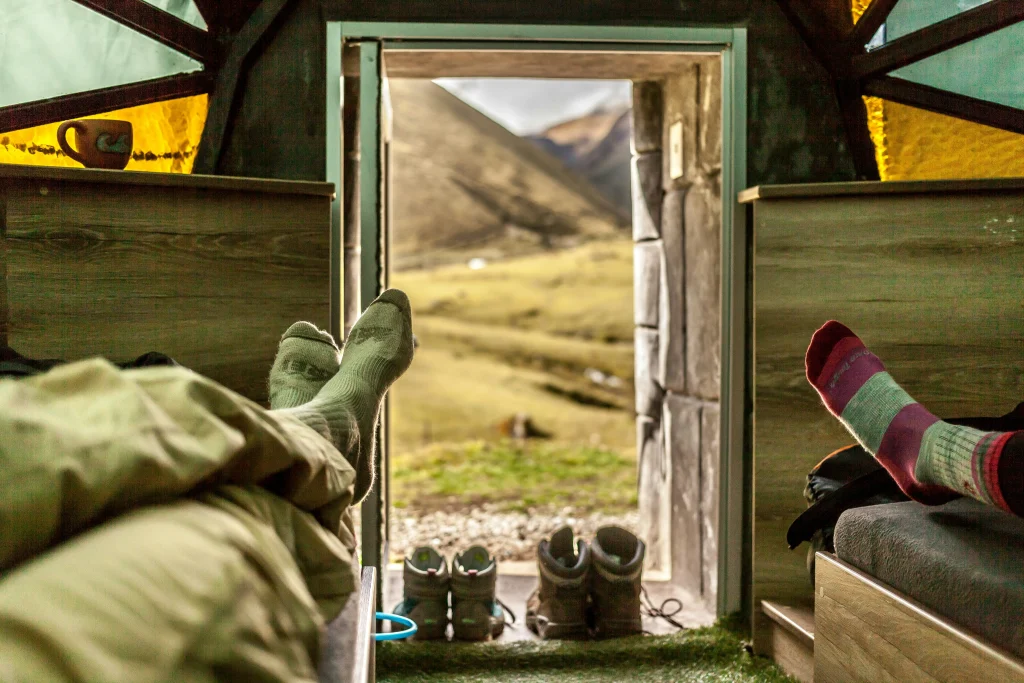 Hiker wearing socks designed to reduce friction inside hiking boots